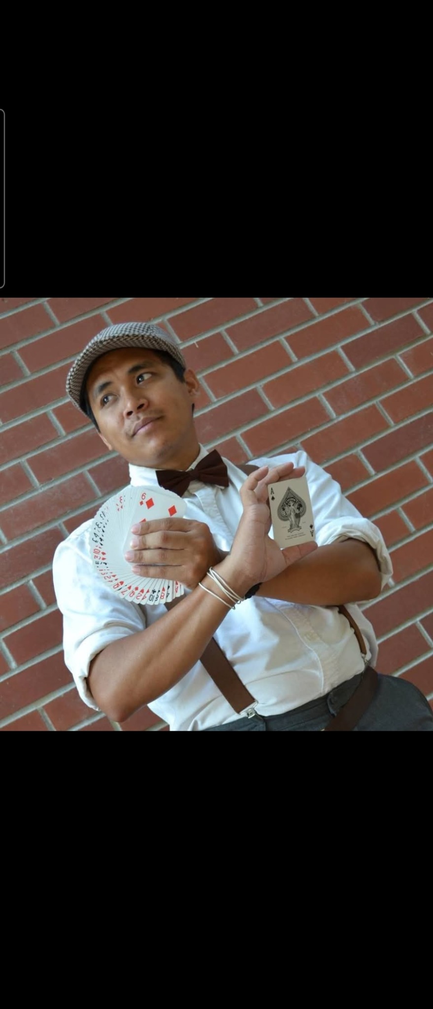 Tetra performing close-up card magic
